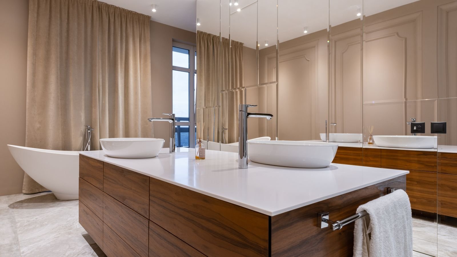 Modern bathroom with a double vanity, vessel sinks and large-format tile