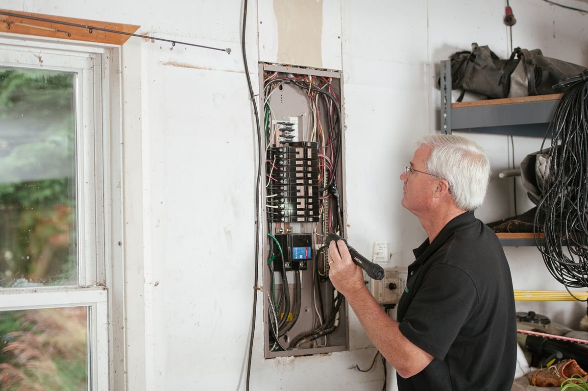 Electrician examining a residential fuse box