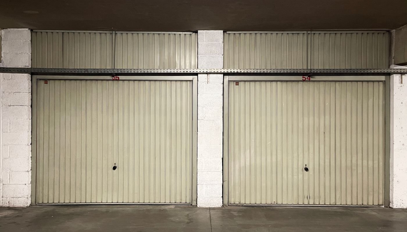 Empty garage interior with bare walls and concrete floor