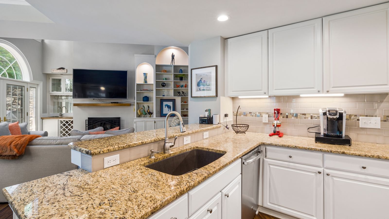White shaker kitchen with granite countertops and stainless appliances, typical of a mid-range 2026 remodel