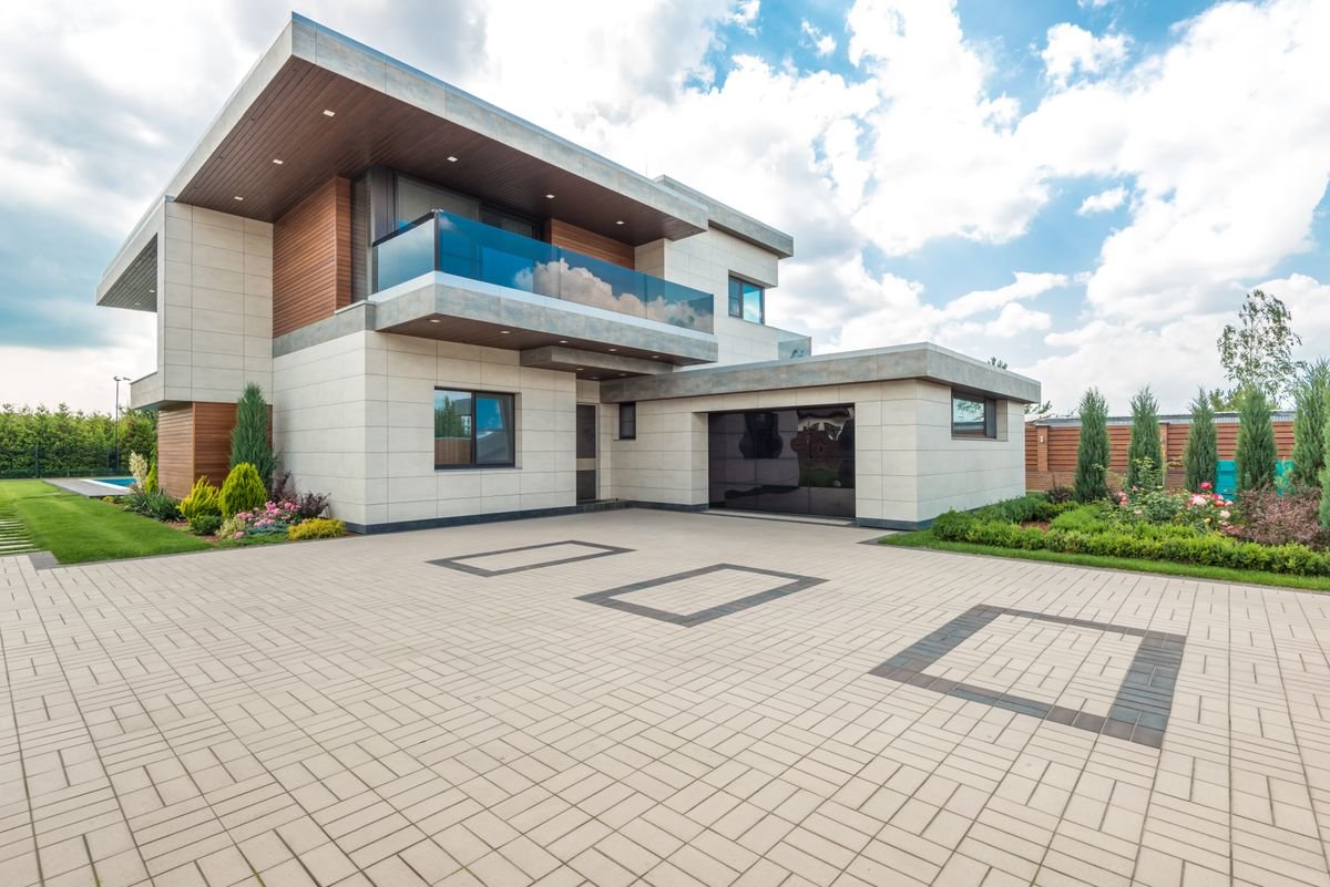 Modern house exterior with greenery and a wide driveway