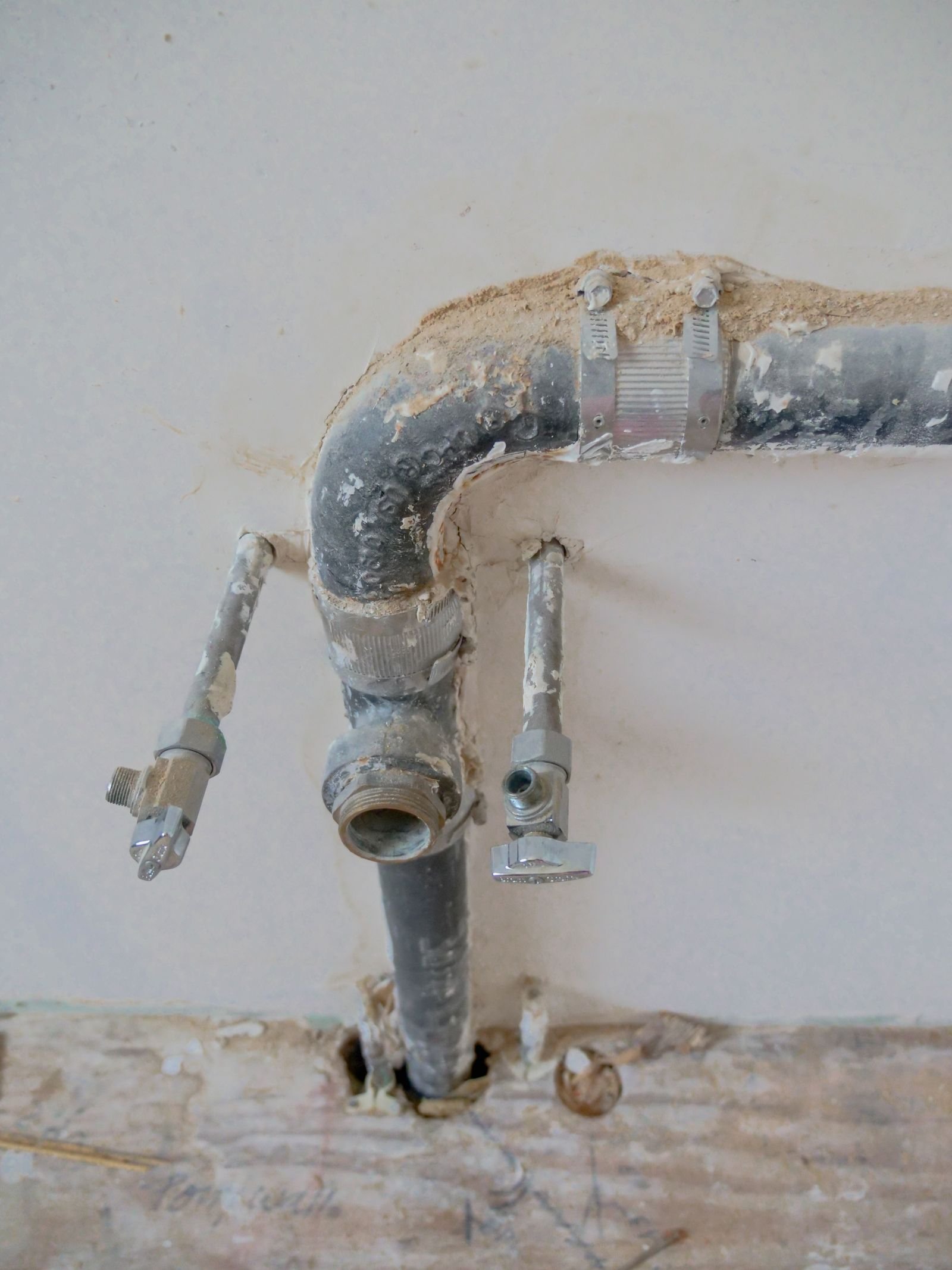 A plumber fitting pipework by hand