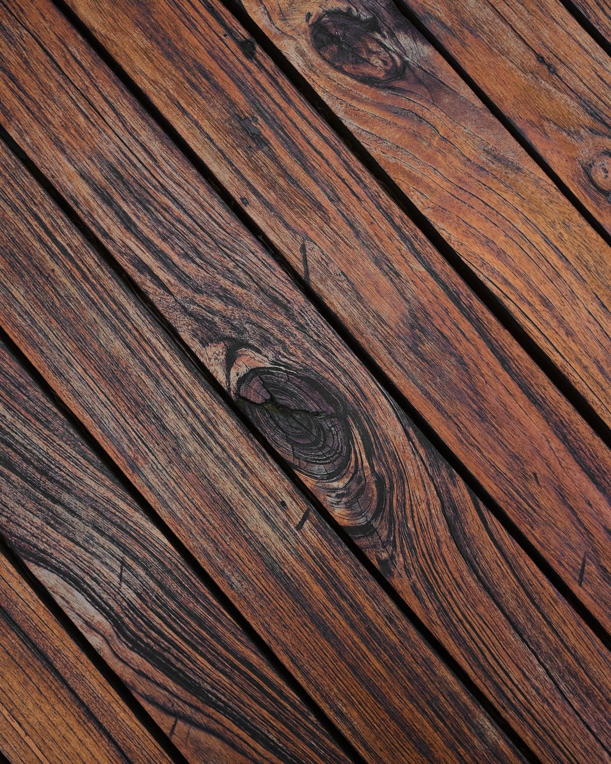 Close-up of weathered wooden deck planks showing grain and texture