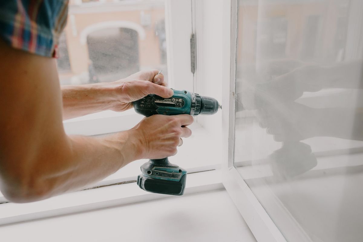 Installer fitting a new window into an opening