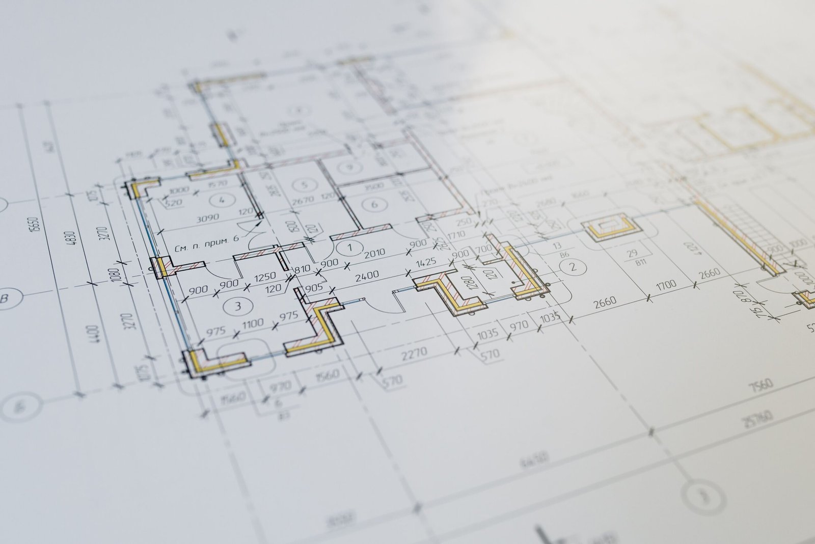 Architectural drawings and a building permit application on a desk