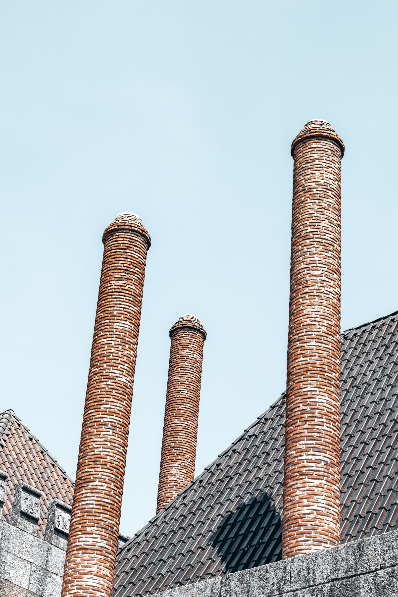 Brick chimney on a tiled roof