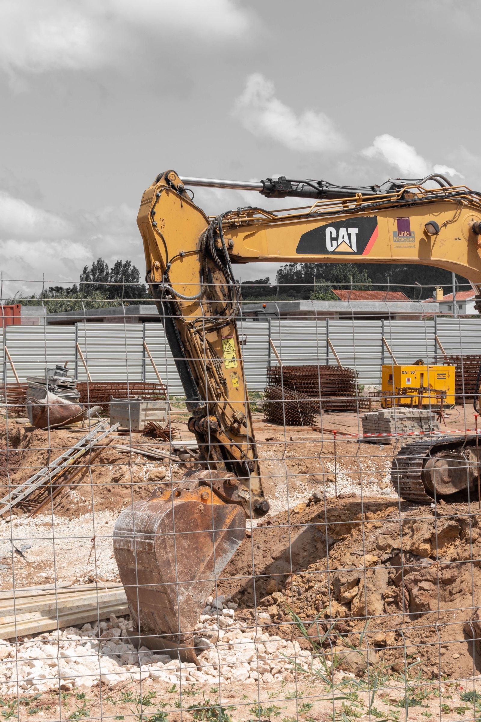 Excavator digging a trench in a garden